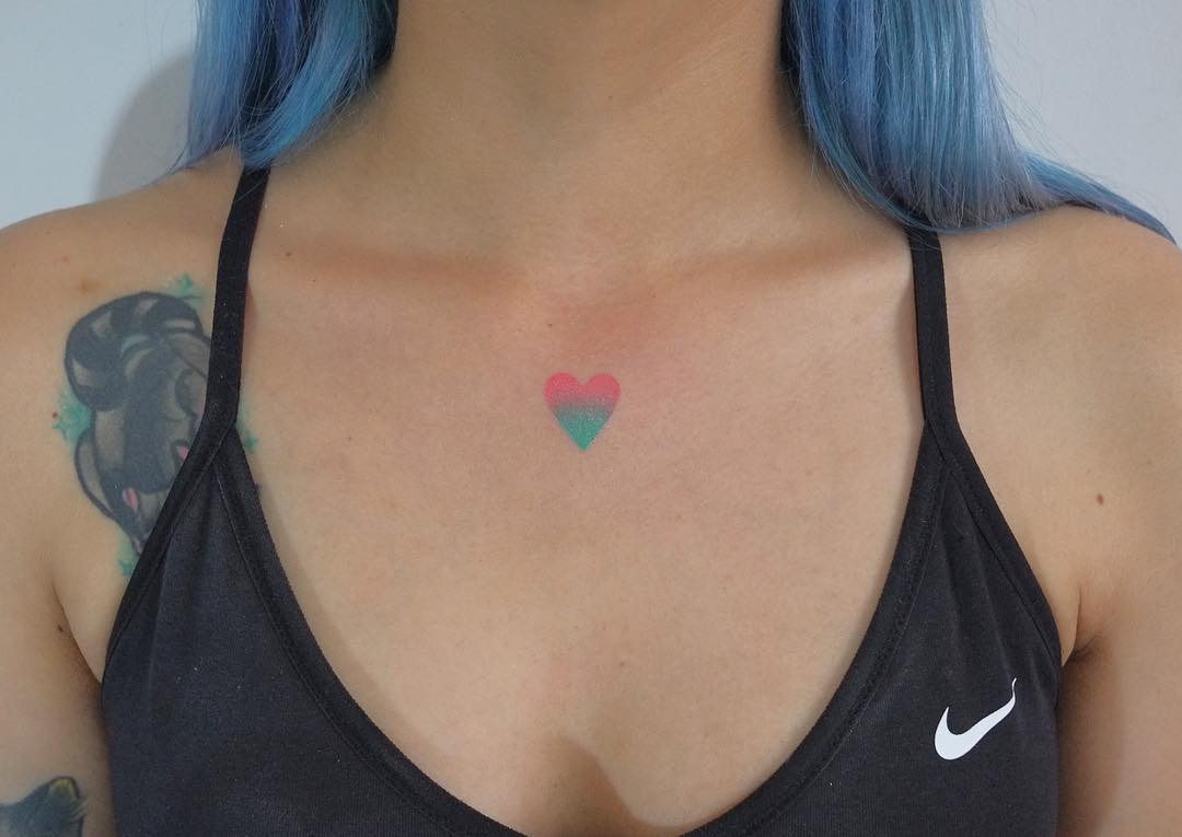 Small heart tattoo on the collarbone