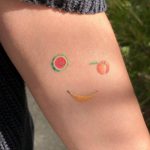 Smiley fruits tattoo