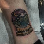 Snow globe with a landscape tattoo