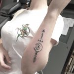 Stylized arrow and crescent moon tattoo