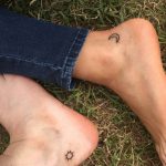 Sun and moon tattoos on feet