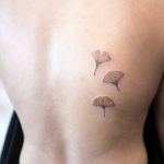 Three ginko leaf tattoos on the back