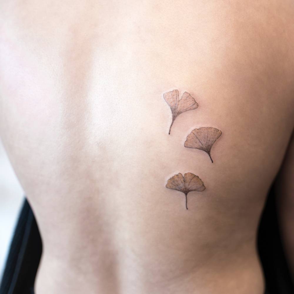 Three ginkgo leaf tattoos on the back