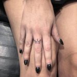 Tiny crown tattoo on the finger