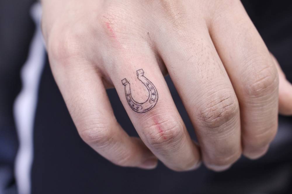 Tiny horseshoe tattoo