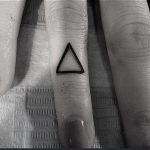 Tiny triangle tattoo on the finger