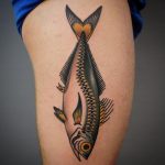 Traditional fish tattoo on the thigh