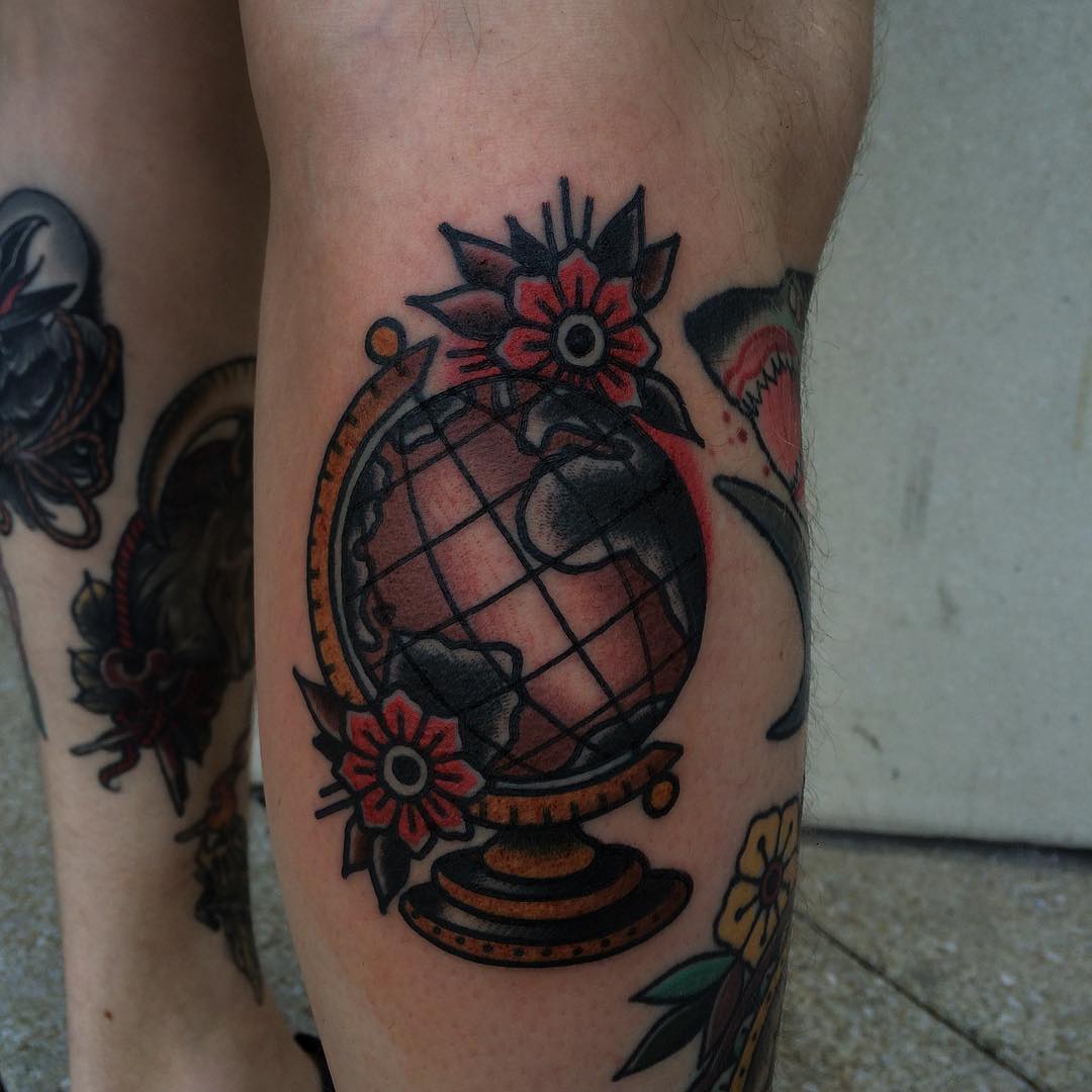Traditional globe and flowers tattoo