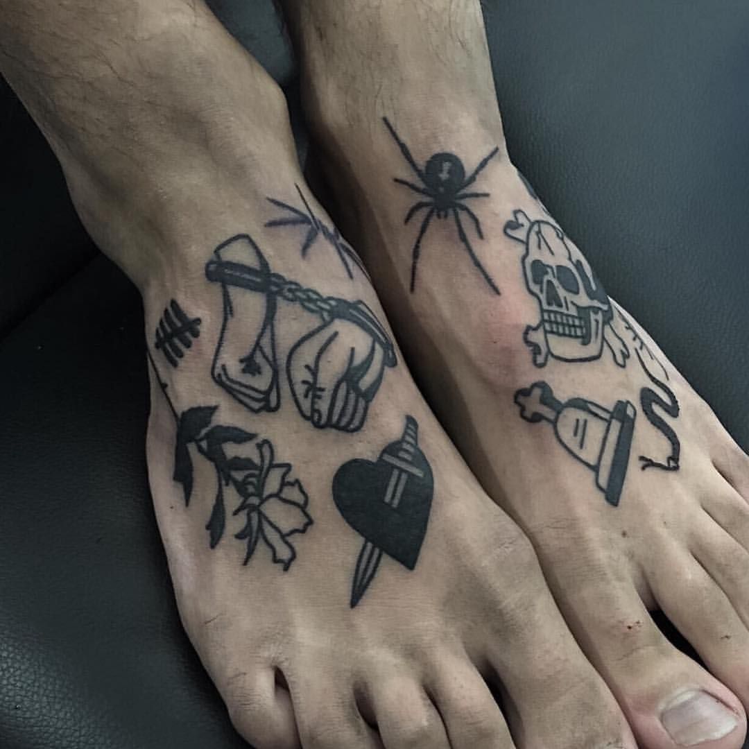 Various black tattoos on feet