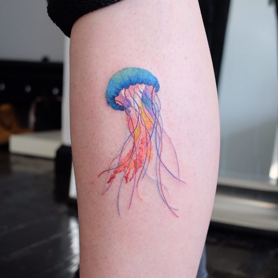 Watercolor jellyfish tattoo on the calf