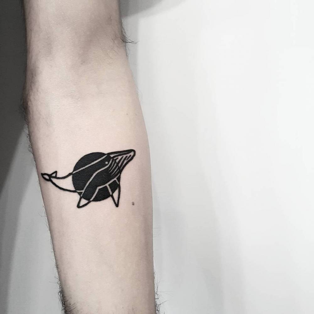 Whale and black circle tattoo