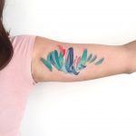 Abstract colorful tattoo on the bicep