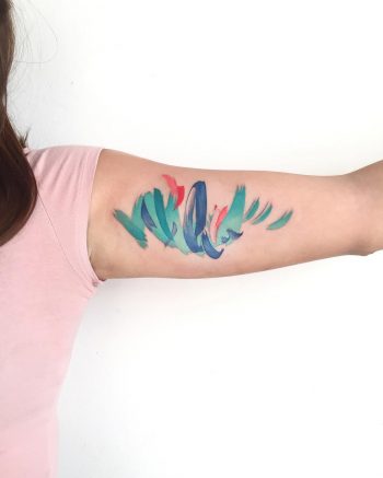 Abstract colorful tattoo on the bicep
