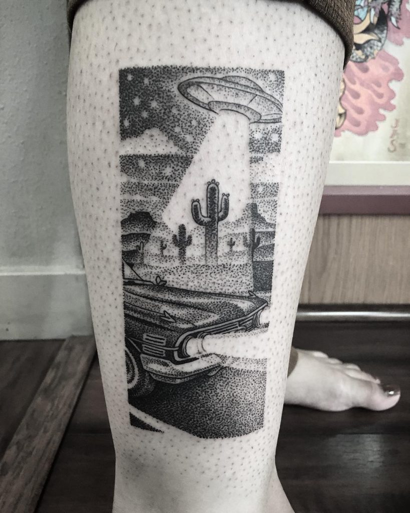 Black and grey alien abduction scenery tattoo