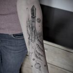 Black and grey rocket tattoo