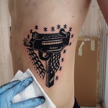 Black and grey uzi tattoo