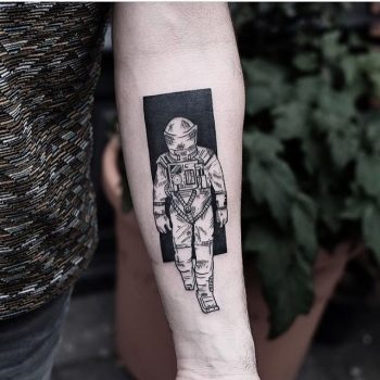 Black and white astronaut tattoo