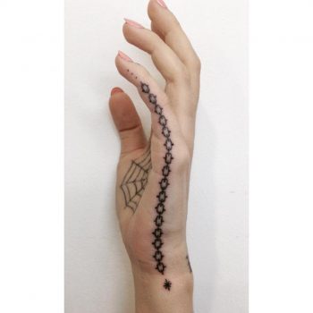 Black chain tattoo on the hand