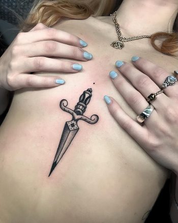 Black dagger tattoo on the sternum