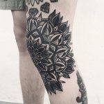 Black floral mandala tattoo on the knee