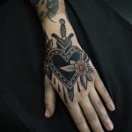 Black heart and dagger tattoo