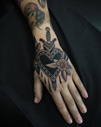 Black heart and dagger tattoo