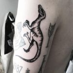 Black raptor tattoo