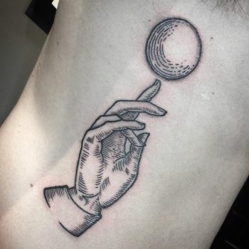 Blackwork style hand and moon tattoo