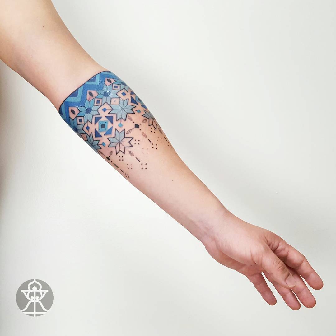 Blue pattern tattoo on the forearm
