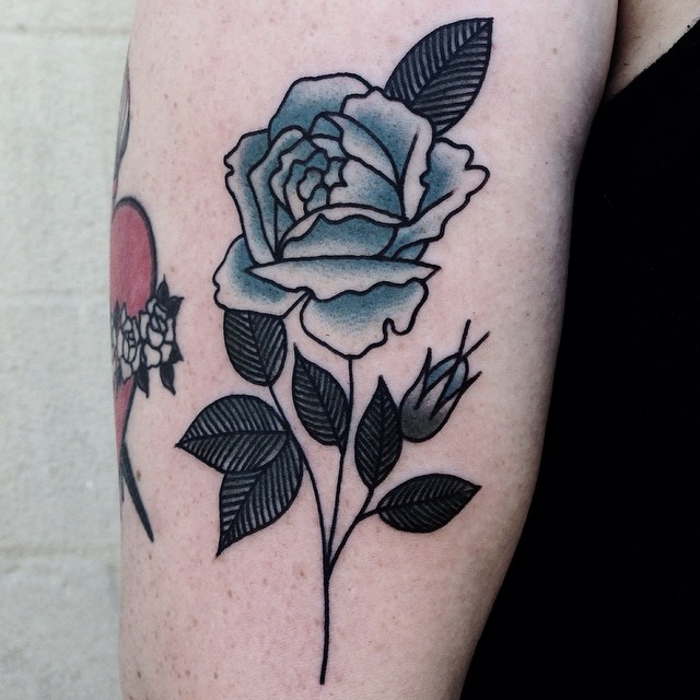 Blue rose tattoo on the bicep
