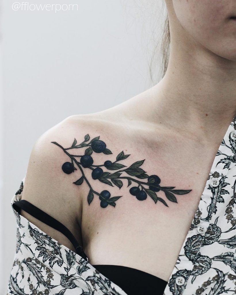 Blueberry tattoo on the collarbone