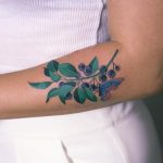 Blueberry tattoo on the forearm