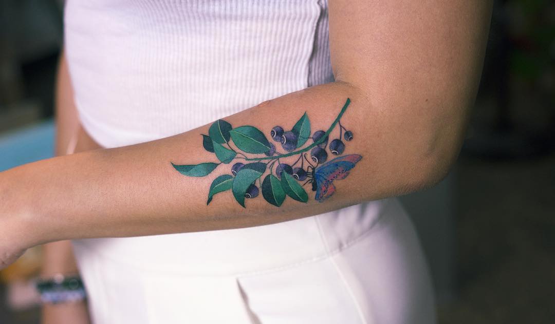 Blueberry tattoo on the forearm