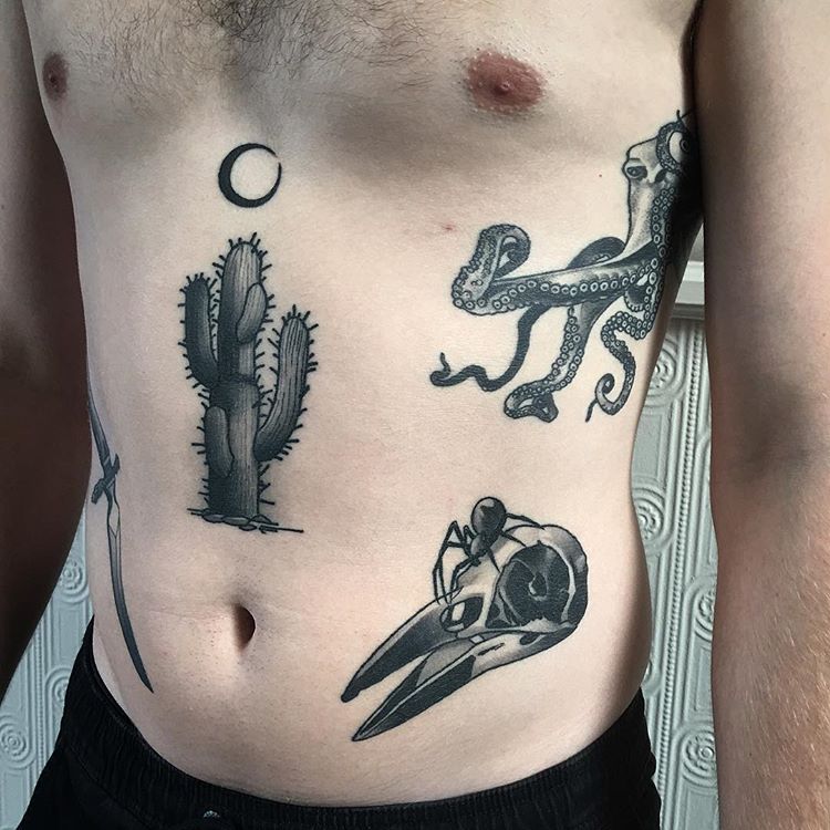 Cactus and crescent moon tattoos on the belly