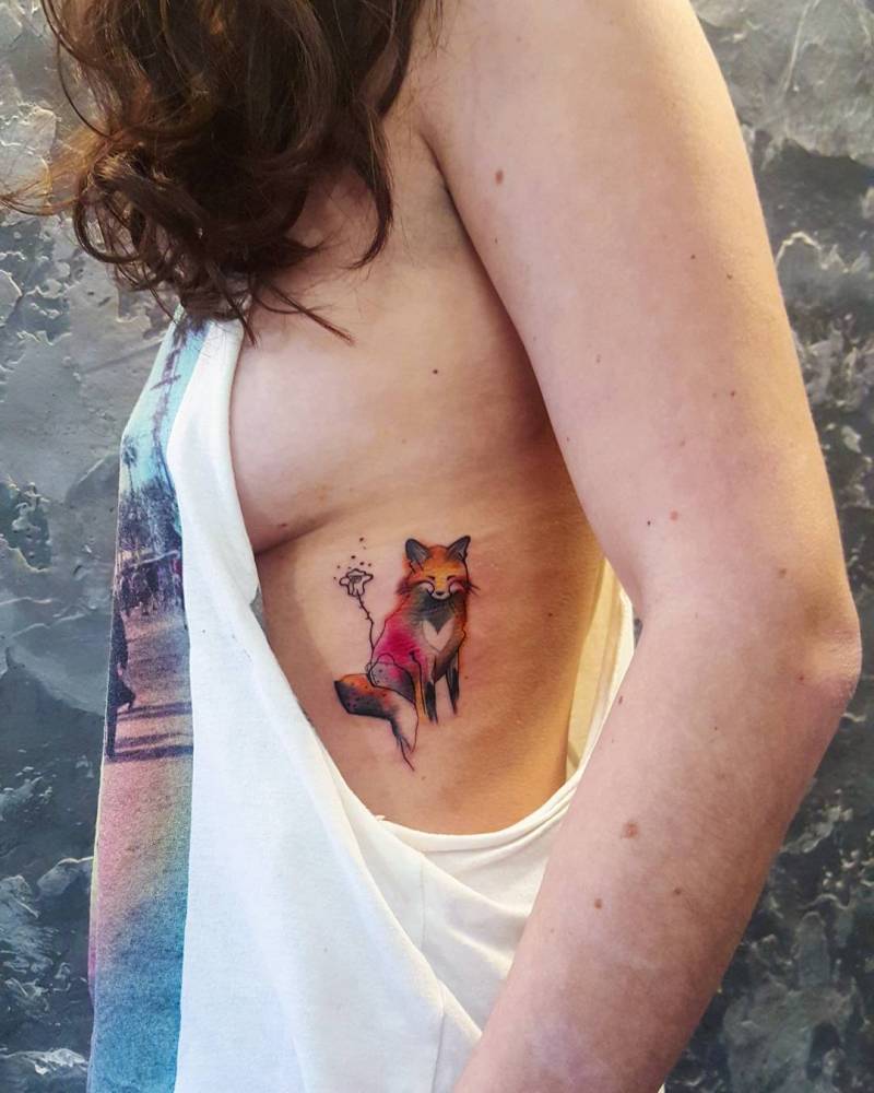 Colorful fox tattoo on the left ribcage