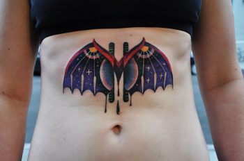 Colorful bat tattoo on the belly