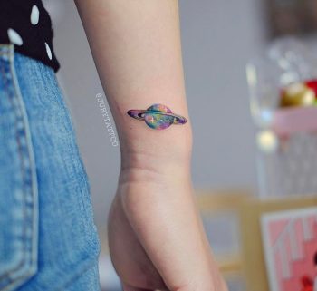 Colorful saturn tattoo on the wrist