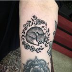 Cute sleeping fox tattoo on the arm
