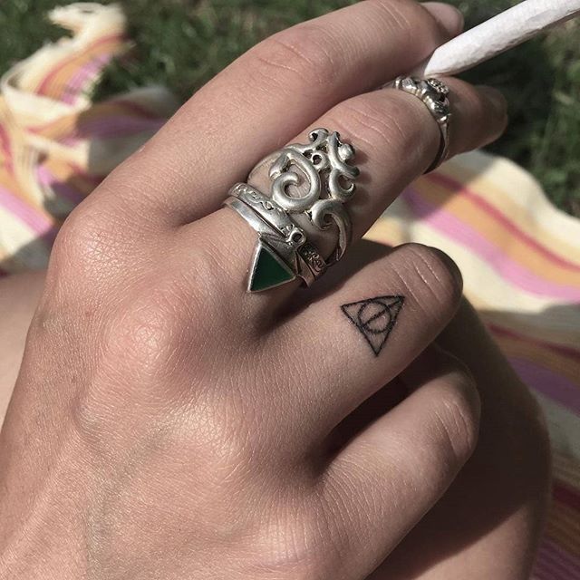Deathly hallows tattoo on a finger 
