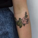 Delicate pink rose tattoo on the arm