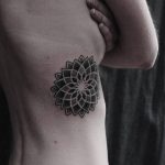 Dotwork mandala tattoo on the right rib cage