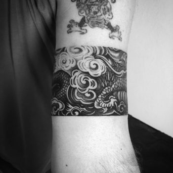 Dragons claw through the clouds tattoo