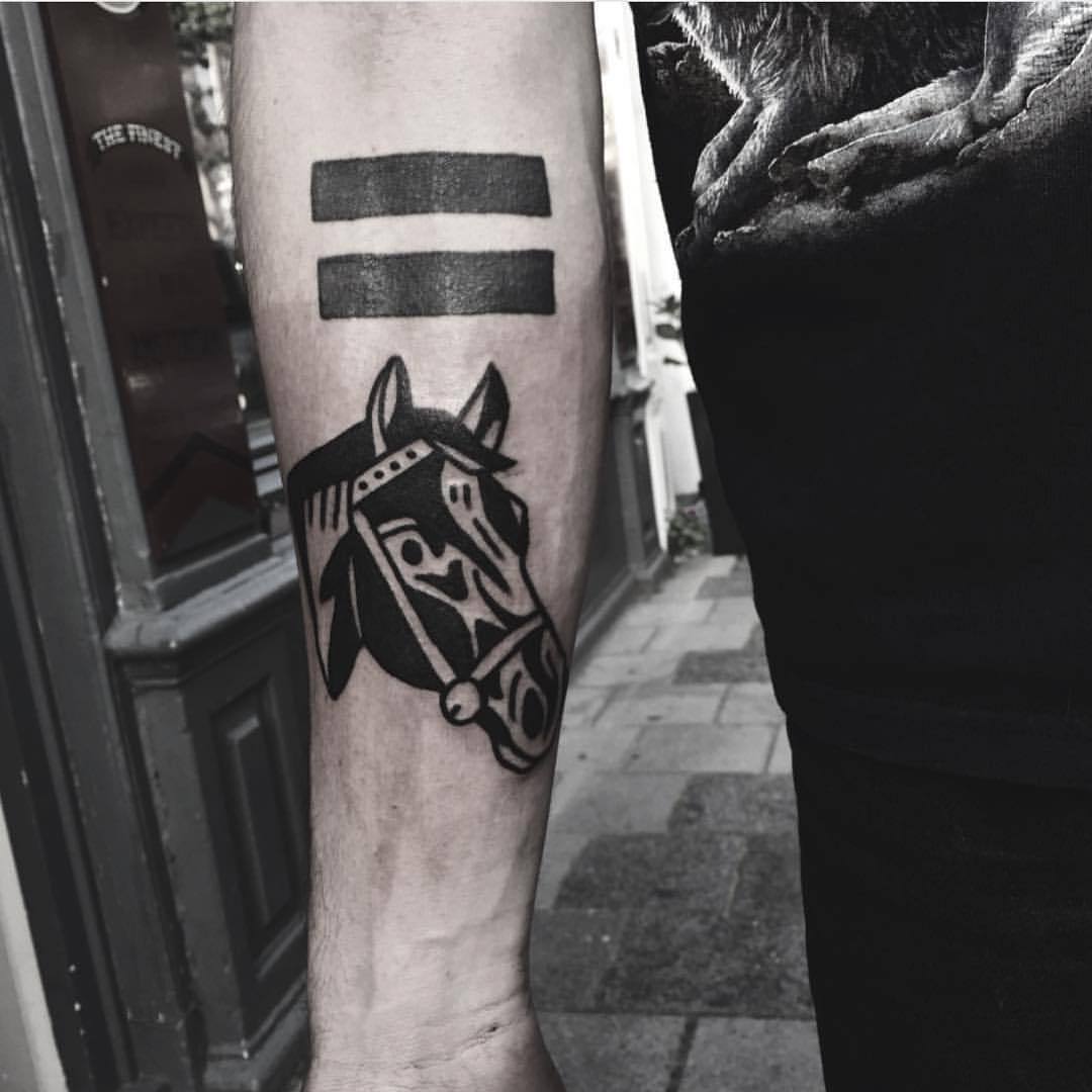 Equals sign and horse head tattoo