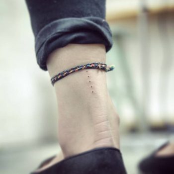 Five tiny dots tattoo on the left achill