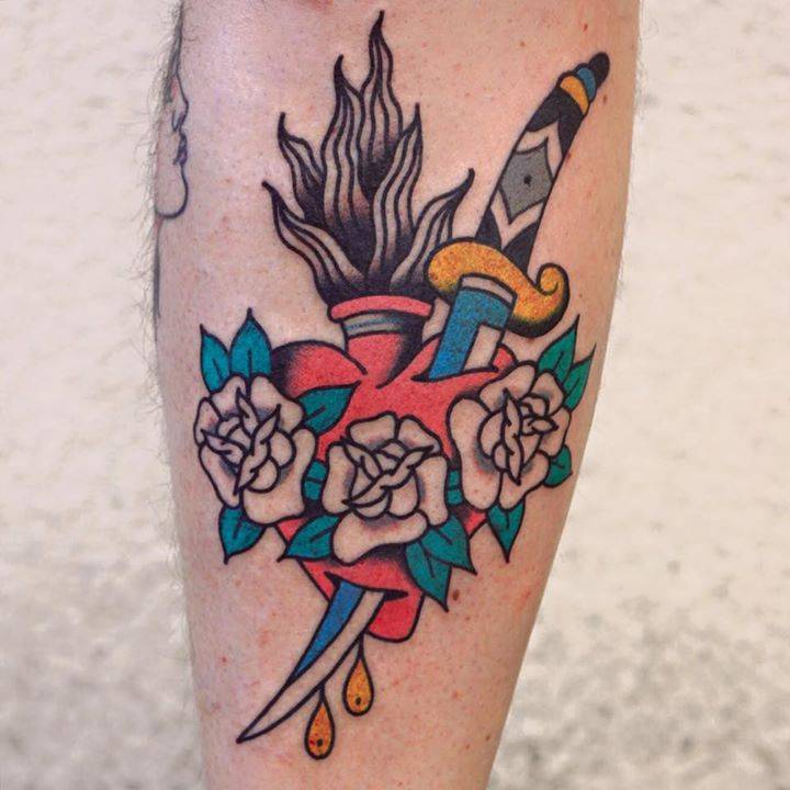 Flaming heart and dagger tattoo