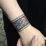 Floral wristband tattoo on the wrist