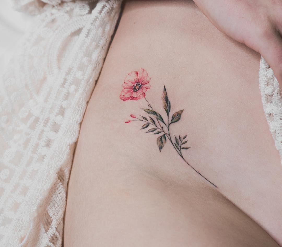 Flower tattoo on the right hip 