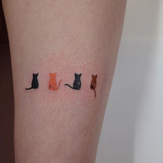 Four small cats tattoo 