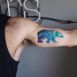 Geometric polar bear tattoo on the bicep