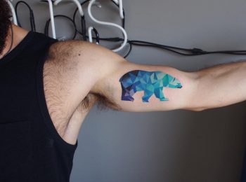 Geometric polar bear tattoo on the bicep